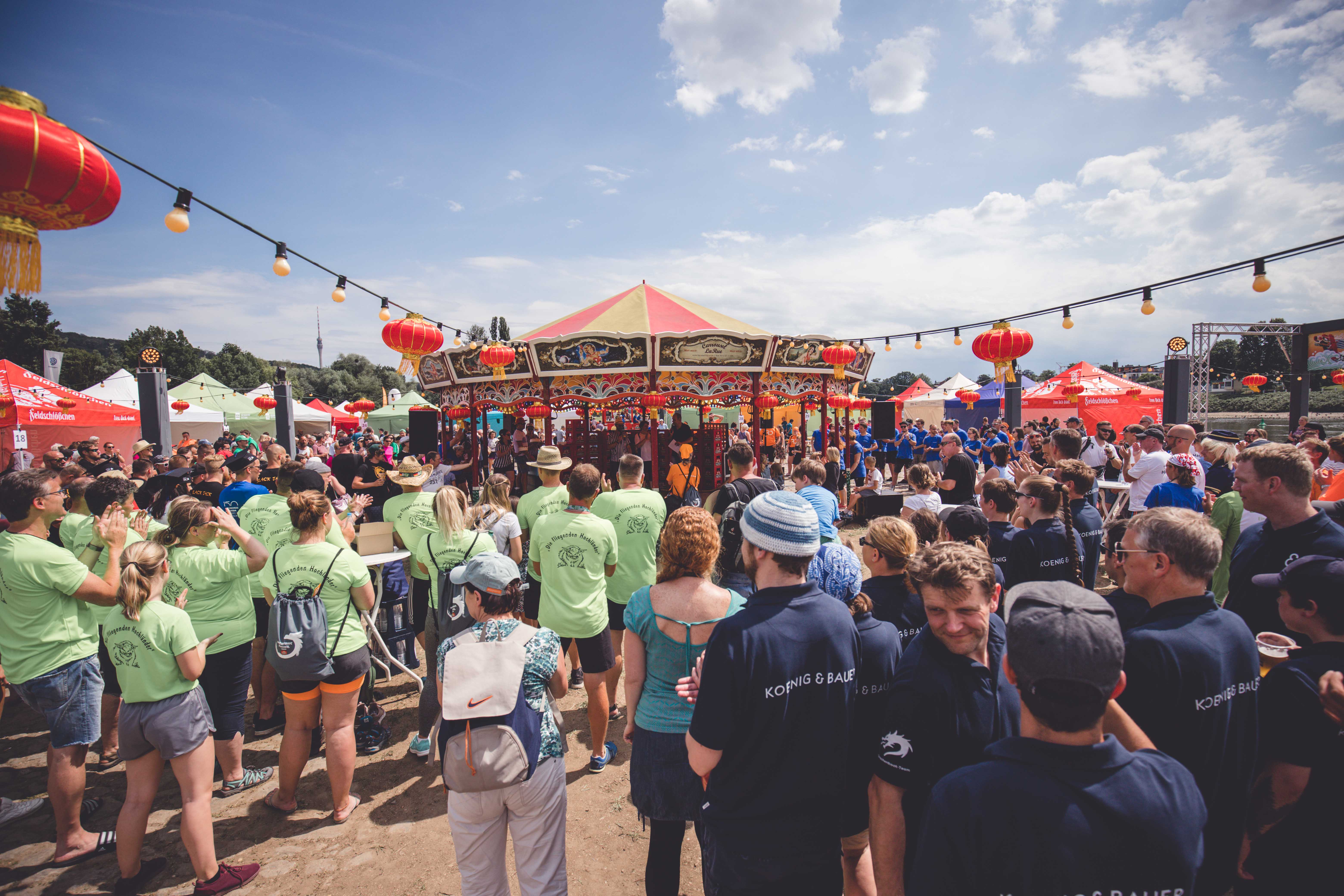  Dragon boat racing teams in different jerseys wait for the awards ceremony