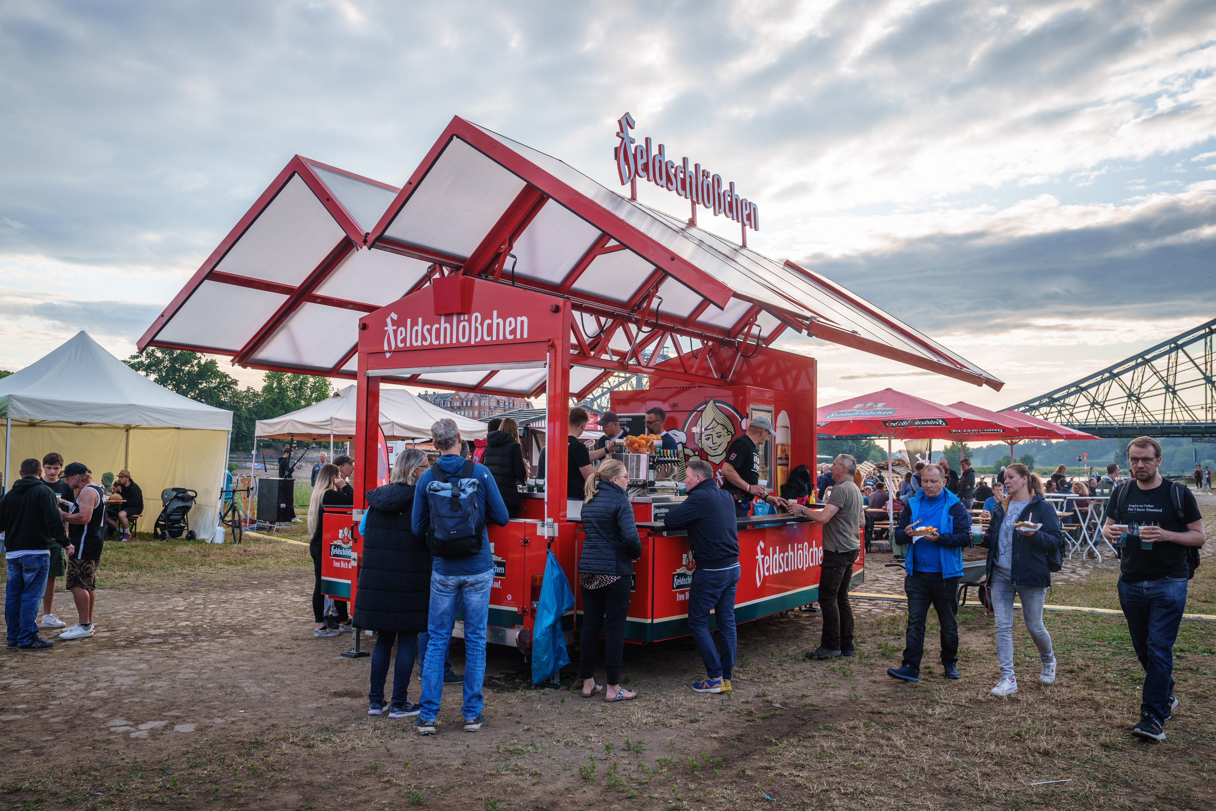 wagons with fresh Feldschlößchen and people enjoying a beer